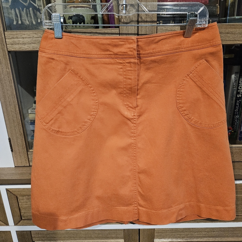 Orange short skirt.